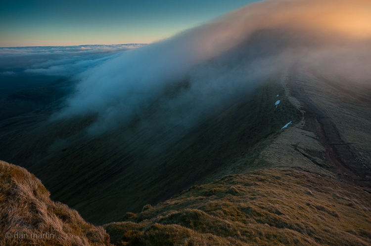 06:59:25 The mist continues its dance; the wind encouraging it to swirl and pivot over the peak, dropping down the other side.  