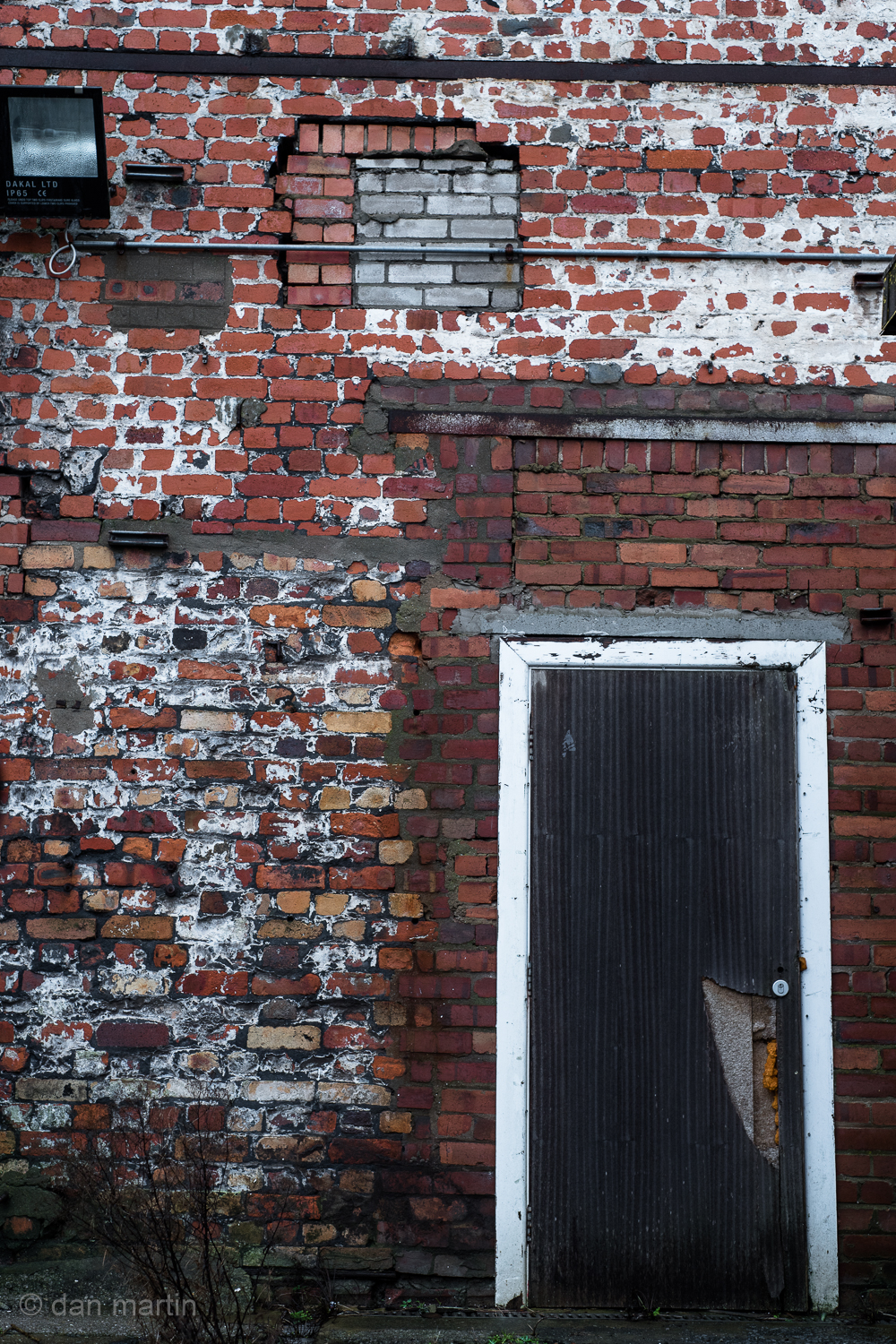Ok, so it may very well be a simple photo of a wall. Its an easy photo. The light is boring. Flat. The wall itself though - it just begs to be seen. To be studied. There is so much going on - the layers of history, previous doorways blocked up, different brick infills; the weathering and individual colours of the bricks. The door - leading to nowhere, disused. Abandoned. A façade belonging to nothing.