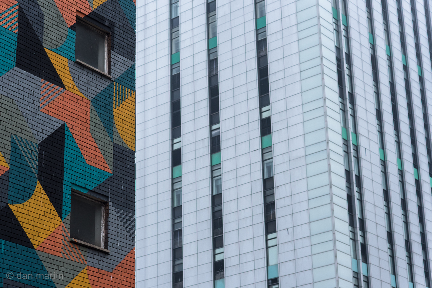 I love the juxtaposition of the coloured building against your typical drab monochromatic city slab.